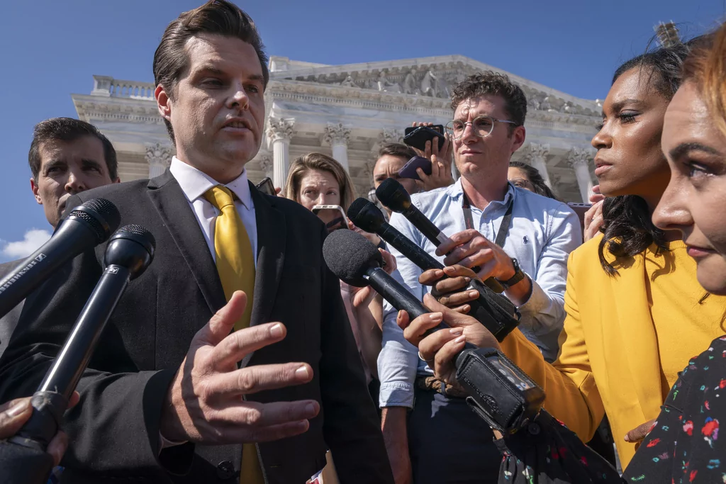 Rep. Matt Gaetz, R-Fla., left, one of House Speaker Kevin McCarthy's harshest critics, answers questions from members of the media after speaking on the House floor, at the Capitol in Washington, Monday, Oct. 2, 2023. Gaetz has said he plans to use a procedural tool called a motion to vacate to try and strip McCarthy of his office as soon as this week. (AP Photo/Jacquelyn Martin)