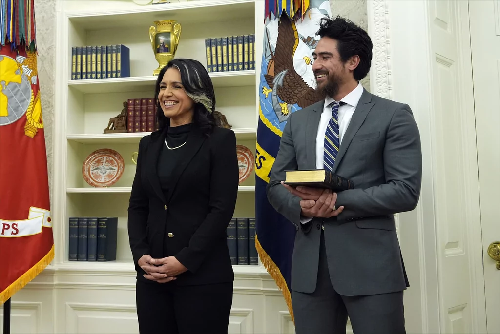 Tulsi Gabbard and her husband Abraham Williams listen before she is sworn in as the Director of National Intelligence in the Oval Office at the White House, Wednesday, Feb. 12, 2025, in Washington. (Photo/Alex Brandon)