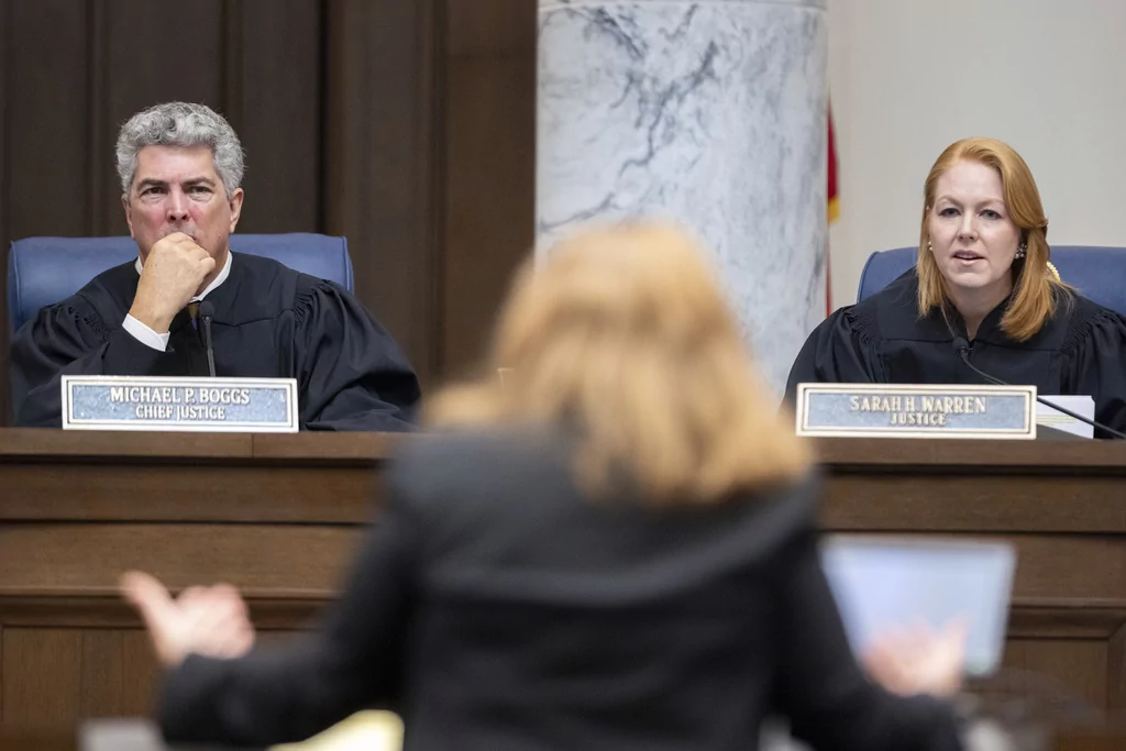 FILE - Georgia Supreme Court Chief Justice Michael Boggs and Justice Sarah Warren listen to oral arguments from attorney Elizabeth Young, representing the Secretary of State, at the Supreme Court in Atlanta, Sept. 24, 2024. (Arvin Temkar/Atlanta Journal-Constitution via AP, File)