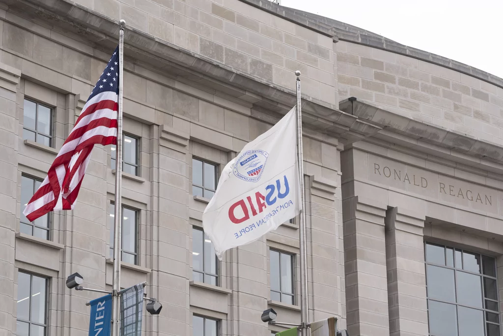 The flag of the U.S. Agency for International Development flies alongside the American flag in front the USAID office in Washington, Monday, Feb. 3, 2025.