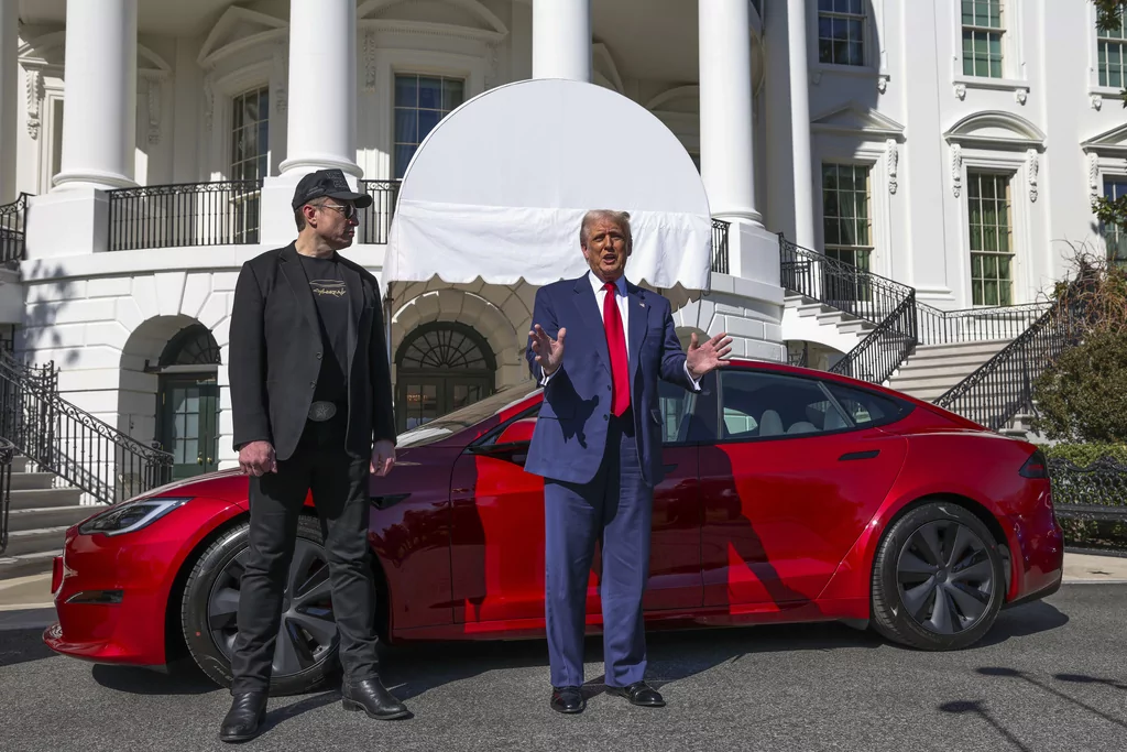 President Donald Trump and Tesla CEO Elon Musk speak to reporters in front of a red Model S Tesla vehicle on the South Lawn of the White House Tuesday, March 11, 2025, in Washington. 