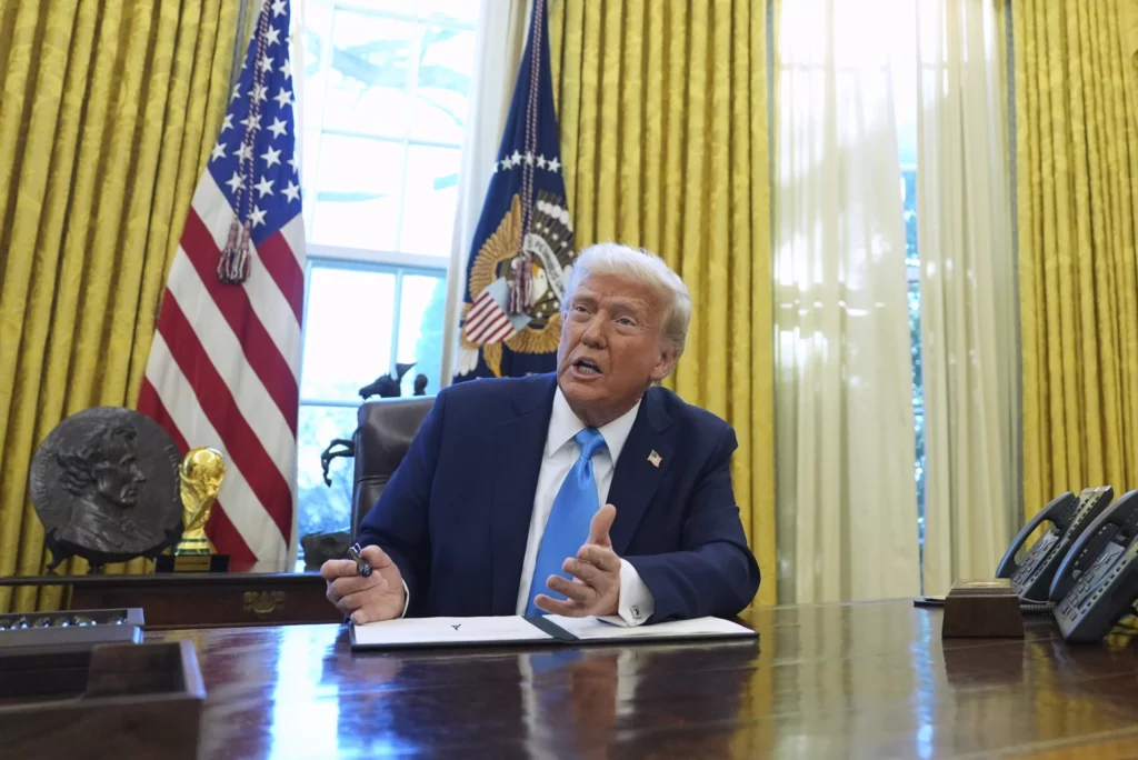 President Donald Trump speaks to reporters as he signs executive orders in the White House, Tuesday, Feb. 4, 2025, in Washington.