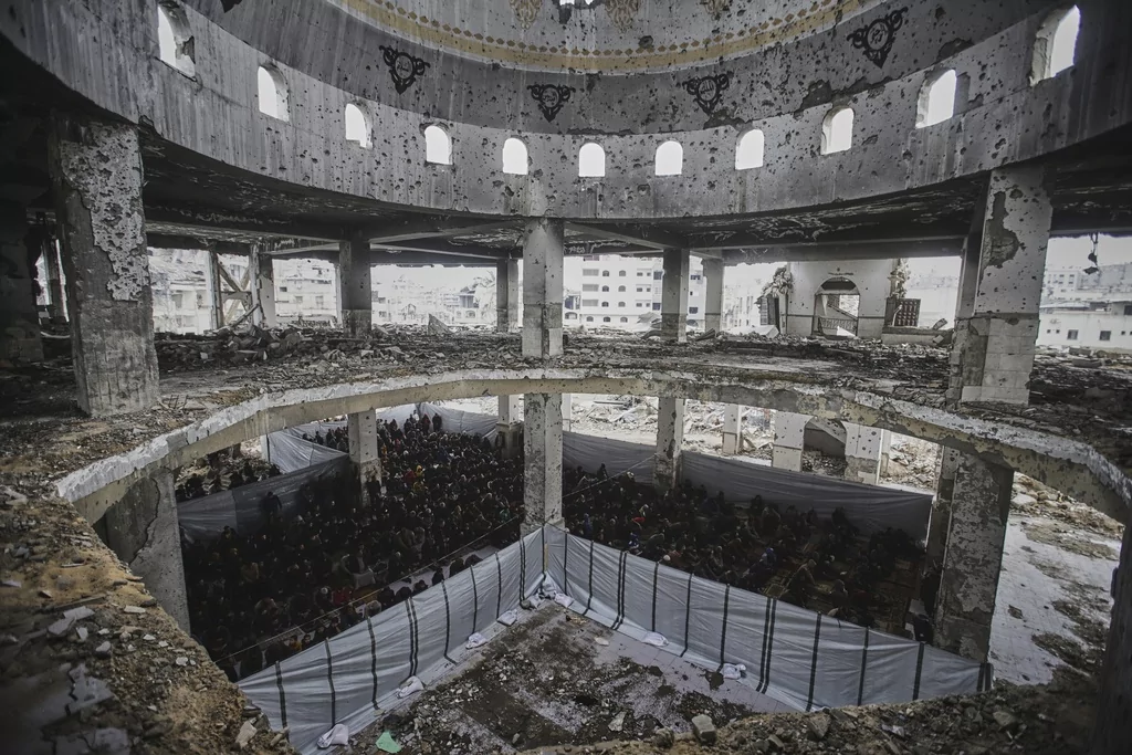 Palestinians pray during the first Friday prayers of the Muslim holy month of Ramadan at the Imam Shafi'i Mosque, damaged by Israeli army strikes, in the Zeitoun neighborhood in Gaza City, Friday March 7, 2025.