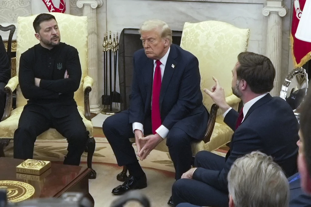 Vice President JD Vance, right, speaks with Ukrainian President Volodymyr Zelenskyy, left, as President Donald Trump listens in the Oval Office at the White House, Friday, Feb. 28, 2025, in Washington.