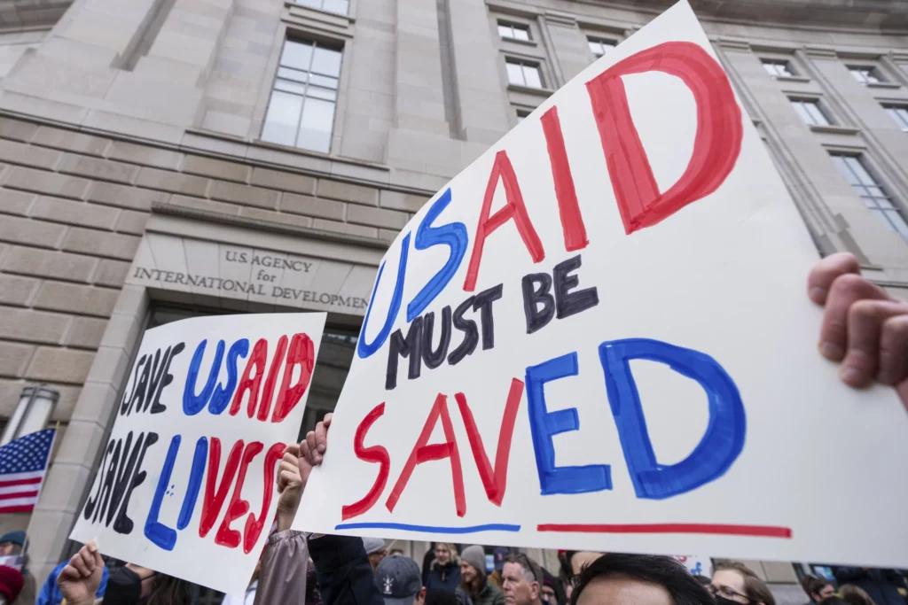 Employees and supporters protest outside the headquarters of the United States Agency for International Development, Monday, Feb. 3, 2025, after Elon Musk posted on social media that he and President Donald Trump would shut down the agency.