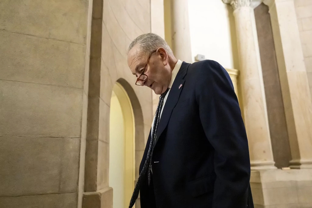 Senate Democratic Leader Chuck Schumer walks near the Senate chamber, as the Senate works to avert a partial government shutdown ahead of the midnight deadline, at the Capitol in Washington, Friday, March 14, 2025. (AP Photo/Ben Curtis)