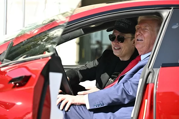 US President Donald Trump and Tesla CEO Elon Musk speak to the press as they sit in a Tesla vehicle on the South Portico of the White House on March 11, 2025 in Washington, DC.