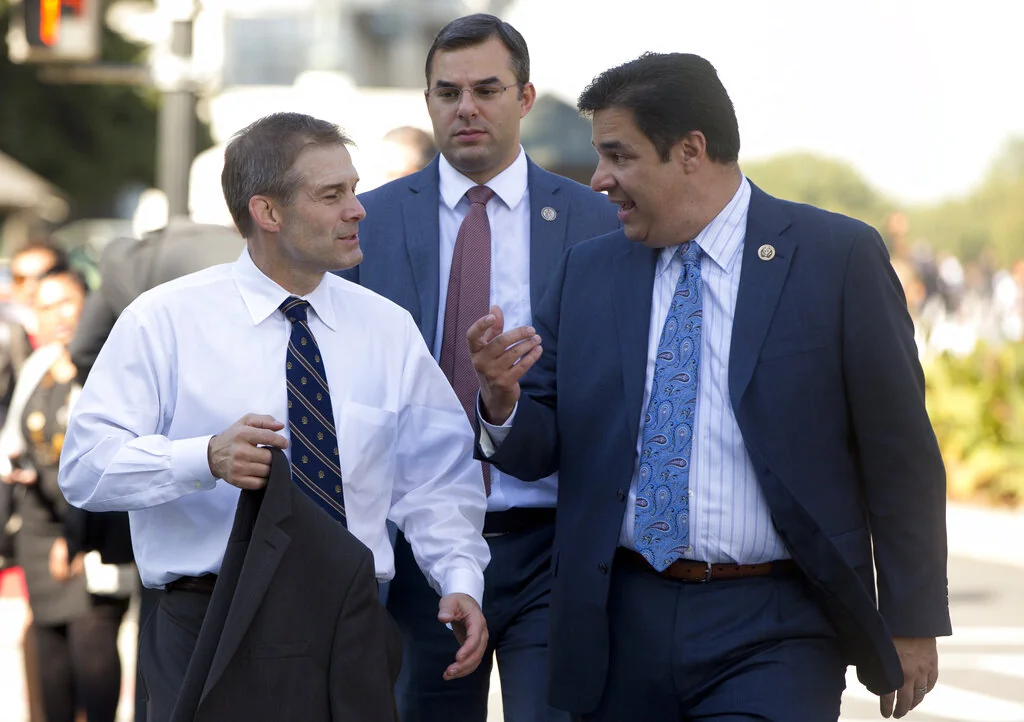 Chair of the Freedom Caucus Rep. Jim Jordan, R-Ohio, left, walks with fellow Freedom Caucus members, Rep. Justin Amash, R-Mich., center, and Rep. Raul Labrador, R-Idaho, fright, from the Capitol to the Longworth House Office Building on Capitol Hill in Washington, Wednesday, Oct. 21, 2015. Rep. Paul Ryan, R-Wis., seeking unity in a place it's rarely found, is telling House Republicans he will serve as their speaker only if they embrace him by week's end as their consensus candidate. (AP Photo/Carolyn Kaster)
