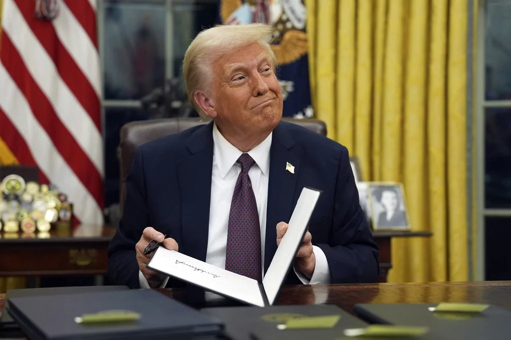 President Donald Trump signs executive orders in the Oval Office of the White House, Monday, Jan. 20, 2025, in Washington.