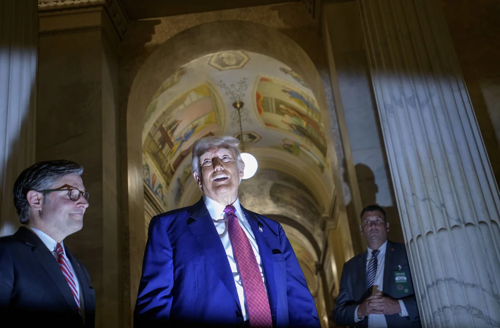 President Donald Trump, right, is joined by Speaker of the House Mike Johnson, R-La., left, as he speaks with reporters upon his departure from the Capitol following a meeting with the House Republican Conference, Tuesday, May 20, 2025, in Washington.