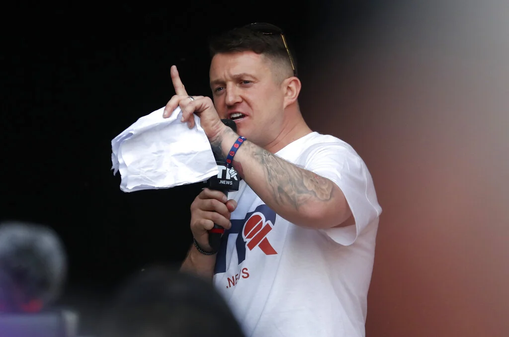 British far-right activist Tommy Robinson speaks during a rally in Parliament Square after the final leg of the "March to Leave" in London, Friday, March 29, 2019. Pro-Brexit demonstrators were gathering in central London on the day that Britain was originally scheduled to leave the European Union.