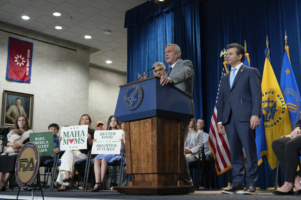 Health and Human Services Secretary Robert F. Kennedy Jr. flanked by Director of the National Institutes of Health Jay Bhattacharya, left, and Food and Drug Administration (FDA) commissioner Marty Makary, right, speaks during a news conference on the FDA's intent to phase out the use of petroleum-based synthetic dyes in the nation's food supply at the Hubert Humphrey Building Auditorium in Washington, Tuesday, April 22, 2025. (AP Photo/Jose Luis Magana)