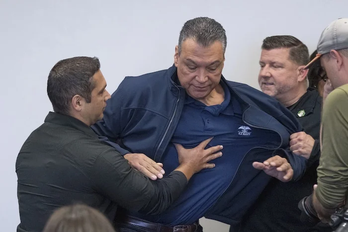 U.S. Sen. Alex Padilla, D-Calif., is pushed out of the room as Homeland Security Secretary Kristi Noem holds a news conference regarding the recent protests in Los Angeles, Thursday, June 12, 2025.