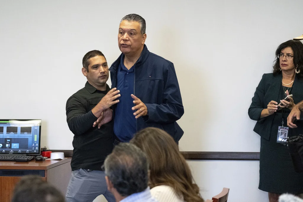 U.S. Sen. Alex Padilla, D-Calif., is pushed out of the room as Homeland Security Secretary Kristi Noem holds a news conference regarding the recent protests in Los Angeles, Thursday, June 12, 2025. (David Crane/The Orange County Register via AP)