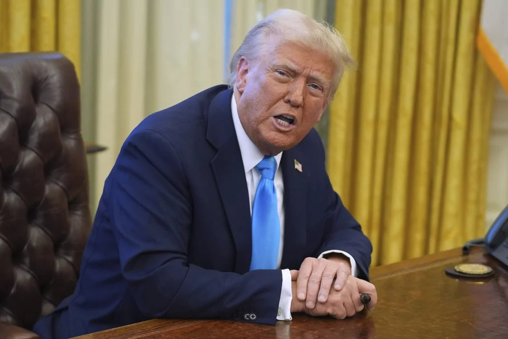 President Donald Trump speaks to reporters as he signs executive orders in the Oval Office of the White House, Tuesday, Feb. 4, 2025, in Washington. (AP Photo/Evan Vucci)