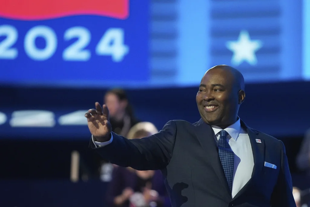 Jaime Harrison, chair of the Democratic National Committee, waves during the Democratic National Convention Monday, Aug. 19, 2024, in Chicago.