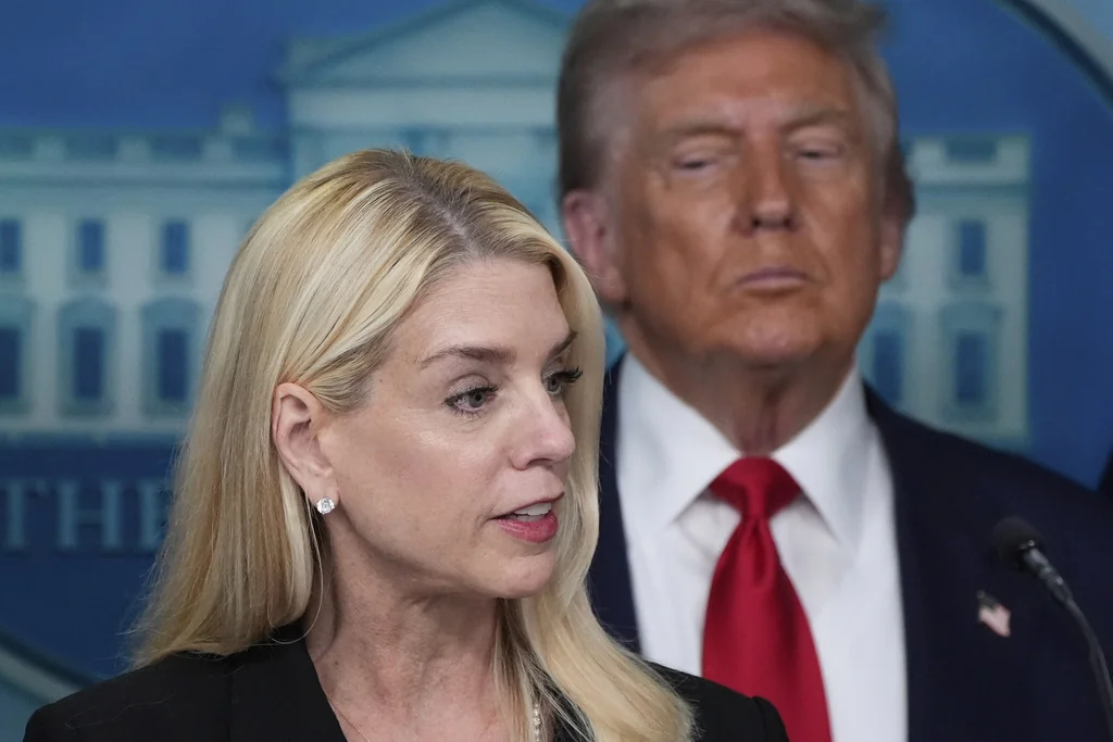 Attorney General Pam Bondi speaks with reporters in the James Brady Press Briefing Room at the White House, Monday, Aug. 11, 2025, in Washington, as President Donald Trump looks on.