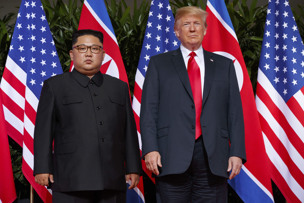 President Donald Trump, right, meets with North Korean leader Kim Jong Un on Sentosa Island, in Singapore, June 12, 2018. 