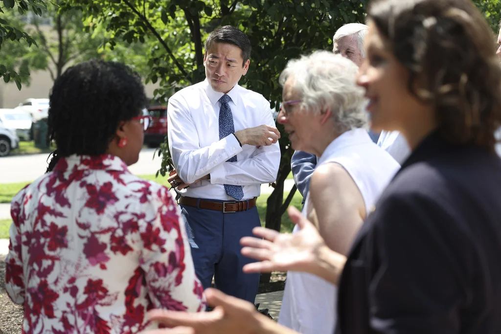 Texas State Rep. Gene Wu, D-Houston, center, talks to Democrat politicians from Indiana, in Chicago, Wednesday, Aug. 13, 2025, before other Texas politicians arrive for a press conference as the Texas Democrats continue to try to prevent a redistricting effort by Republicans in their state.