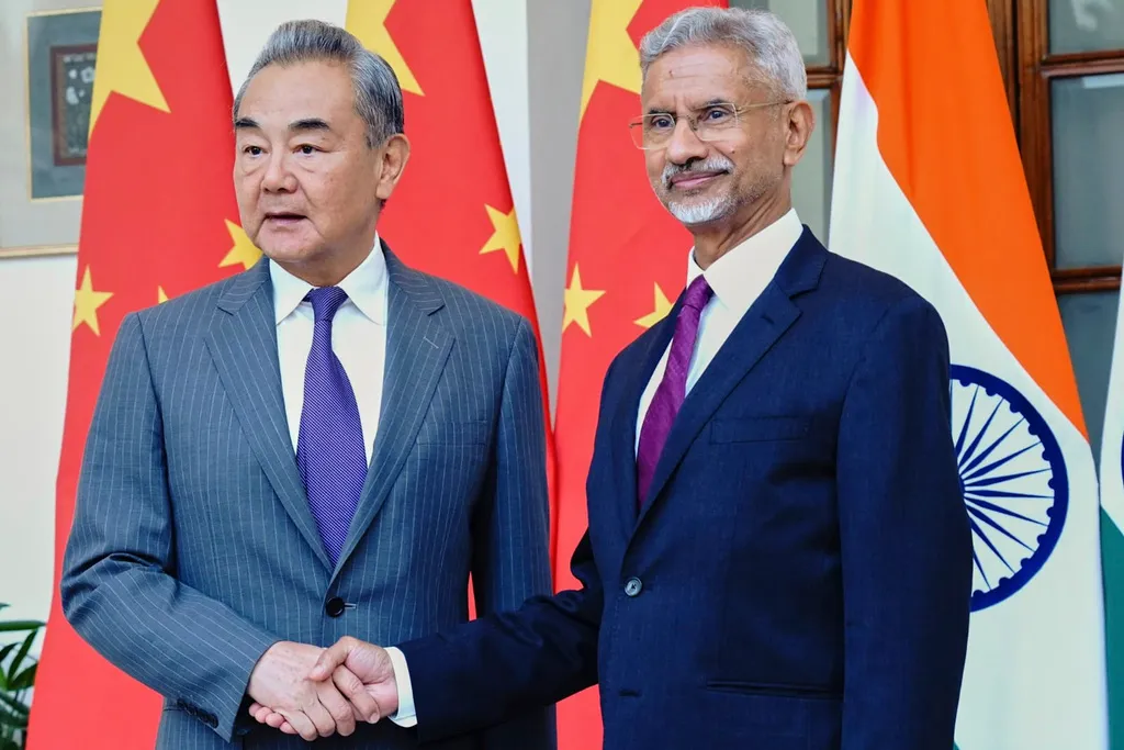 Indian Foreign Minister S. Jaishankar shakes hand with his Chinese counterpart Wang Yi, left, in New Delhi, India, Monday, Aug. 18, 2025. 