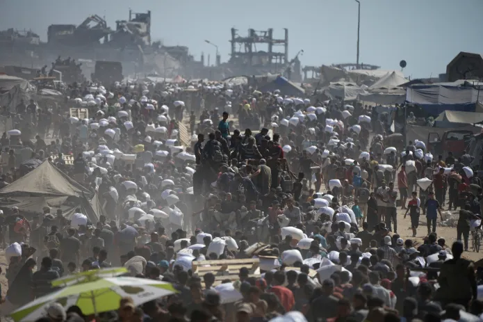 Palestinians carry sacks of flour taken from a humanitarian aid convoy in the outskirts of Beit Lahiya, northern Gaza Strip, Aug. 1, 2025.