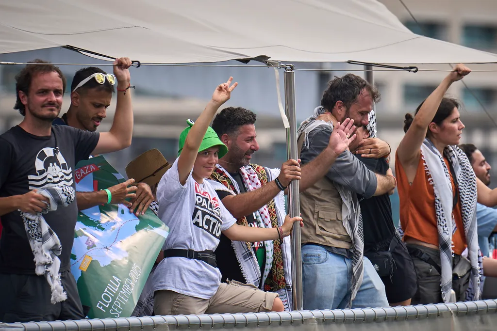 Swedish climate activist Greta Thunberg waves from a boat taking part in a civilian flotilla bound for Gaza, aiming to break the Israeli blockade and deliver humanitarian aid on Sunday, Aug. 31, 2025, in Barcelona, Spain.