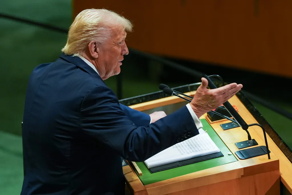 President Donald Trump speaks behind a podium.
