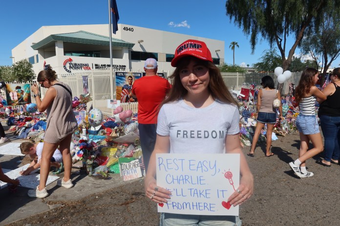 Nicole Gervais, 26, holds up a sign outside of Turning Point USA's headquarters in Phoenix. (Samantha-Jo Roth, Washington Examiner)
