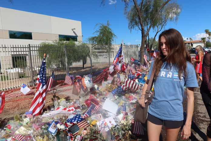Erica Rodriguez, a 24-year-old from Albuquerque, visits Charlie Kirk's memorial outside of Turning Point USA's Phoenix headquarters. (Samantha-Jo Roth, Washington Examiner)