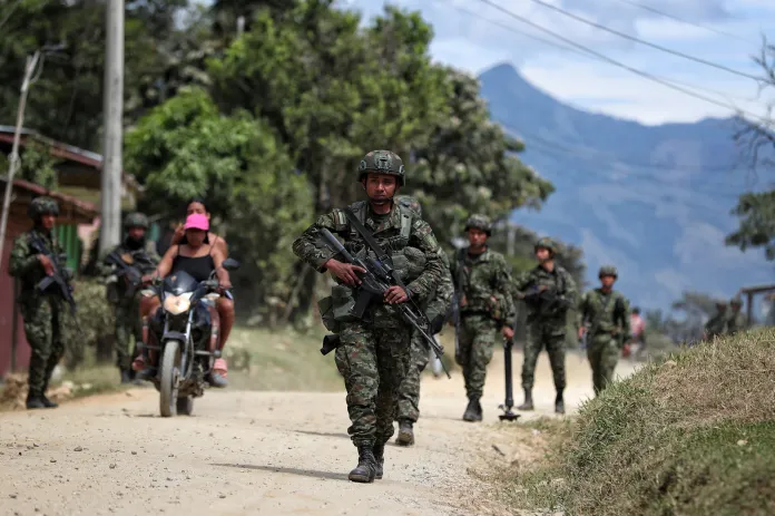 Soldiers patrol a street in El Carmelo, Colombia, a day after a deadly attack on a police station that authorities blame on a dissident faction of the demobilized Revolutionary Armed Forces of Colombia, or FARC, Monday, Sept. 15, 2025.