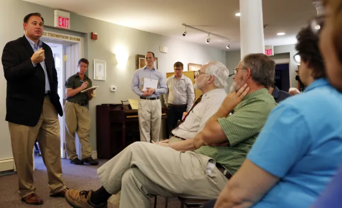 Rep. Frank Guinta (R-NH) speaks to people in a room.
