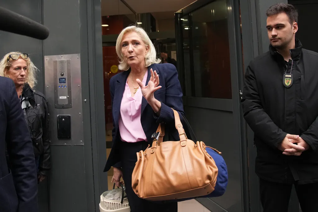 French right-wing leader Marine Le Pen leaves the National Rally party headquarters following a meeting, after France's prime minister, Sebastien Lecornu, resigned, plunging the country into a deep political crisis. Monday, Oct. 6, 2025, in Paris. (AP Photo/Christophe Ena)