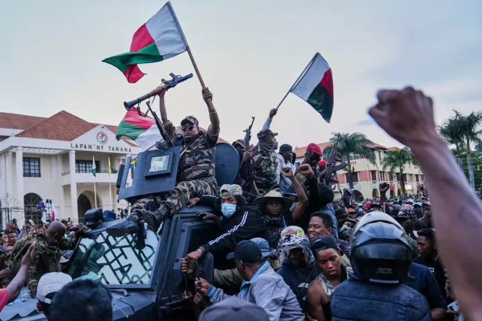 Soldiers are greeted by people gathering for a ceremony in tribute to demonstrators killed during recent anti-government protests in Antananarivo, Madagascar, Sunday, Oct. 12, 2025.