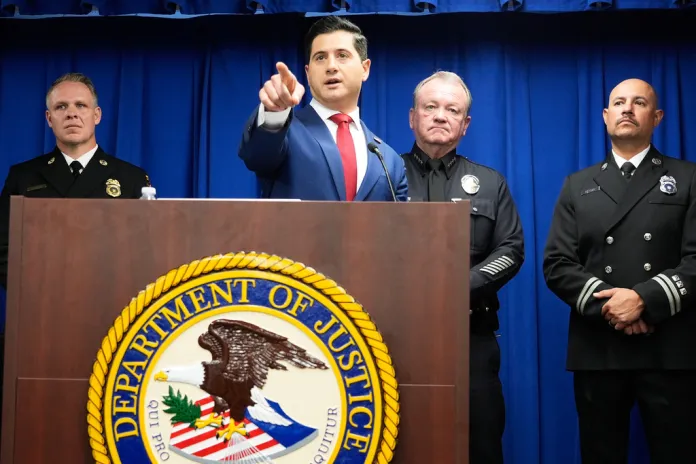 Acting U.S. Attorney Bill Essayli, middle, gestures while speaking during a news conference announcing an arrest made in the Palisades Fire, Wednesday, Oct. 8, 2025, in Los Angeles.