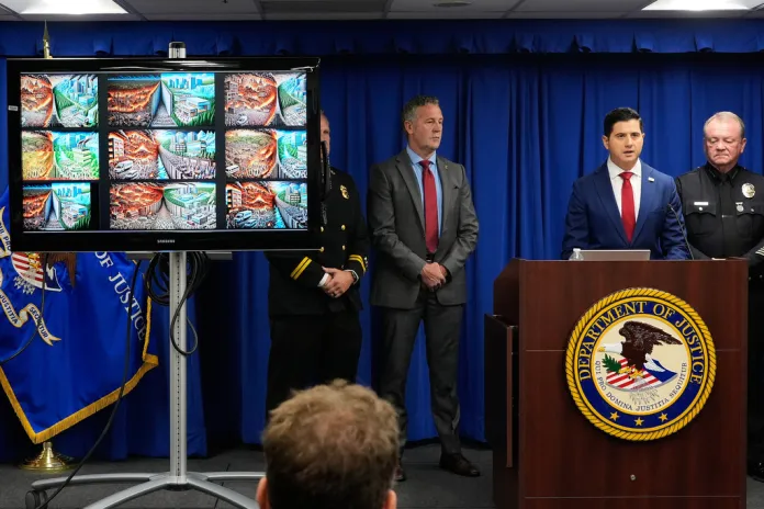 U.S. Attorney Bill Essayli, second from right, speaks between Special Agent in Charge Kenny Cooper, of the Bureau of Alcohol, Tobacco, Firearms and Explosives, Los Angeles Field Division, second from left, and Los Angeles Police Chief Jim McDonnell, right, during a news conference announcing an arrest made in the Palisades Fire, Wednesday, Oct. 8, 2025, in Los Angeles. 