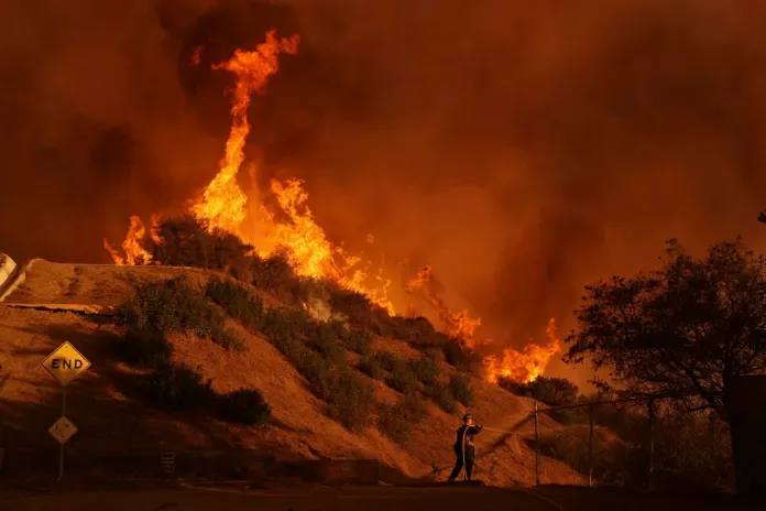 A firefighter battles the Palisades Fire.
