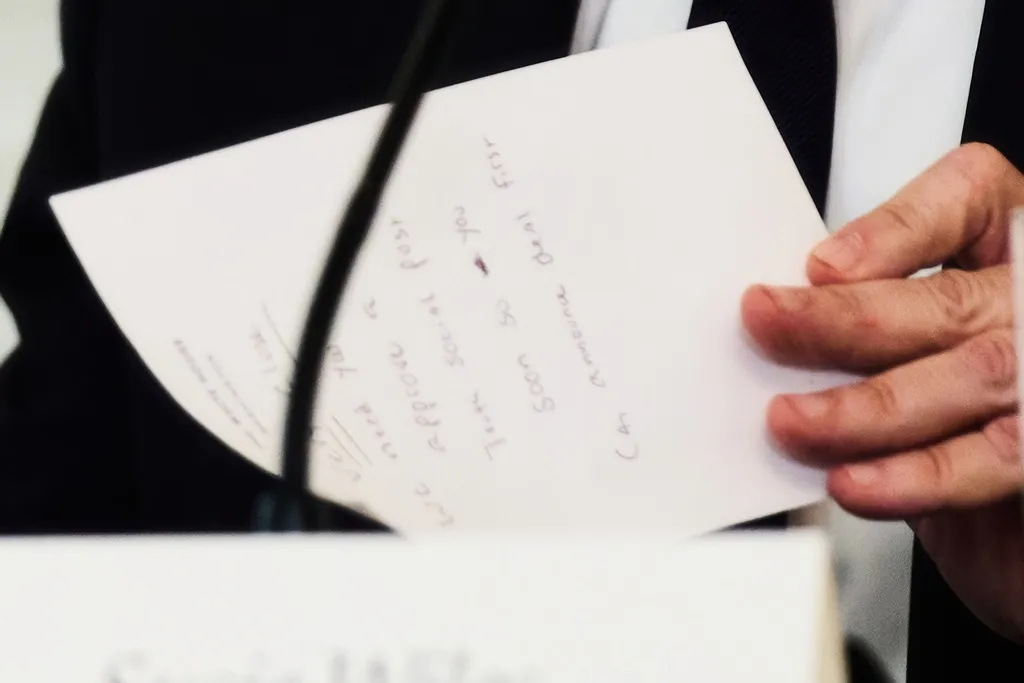 Secretary of State Marco Rubio writes a note.