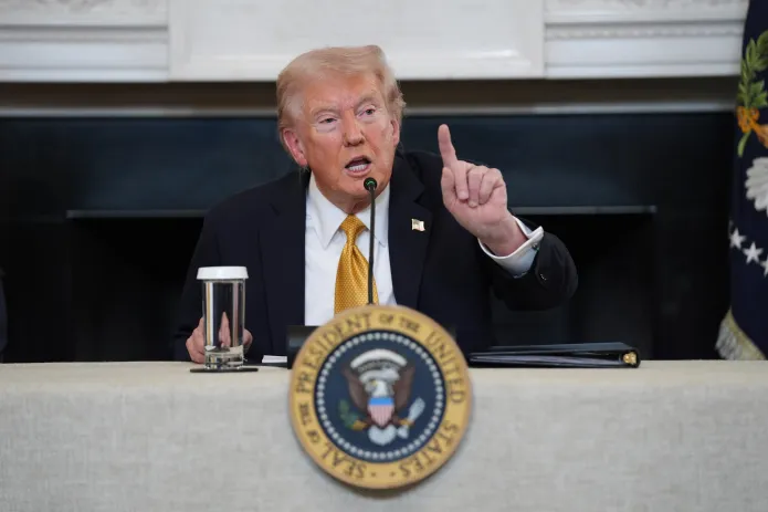 President Donald Trump answers questions at the White House.