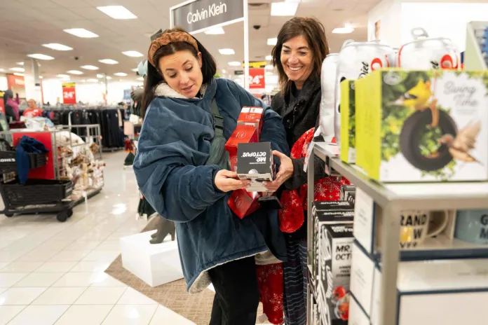 Becca Mendoza and Tammi Hines look at products as shoppers browse through Kohl's department store for Black Friday deals, Friday, Nov. 28, 2025, in Woodstock, Ga. (AP Photo/Megan Varner)