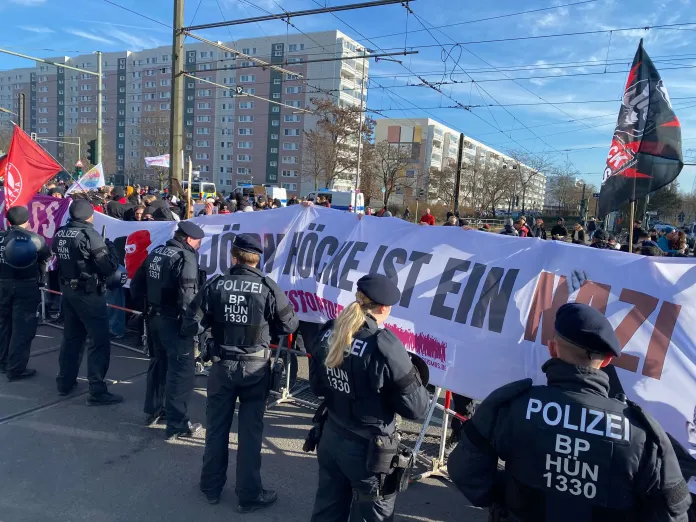 Berlin city police stand in a line around the perimeter of an antifa protest just meters away from the Alternative for Germany rally.