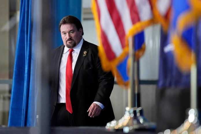Nevada GOP chair Michael McDonald walks on stage for an event with President Donald Trump.