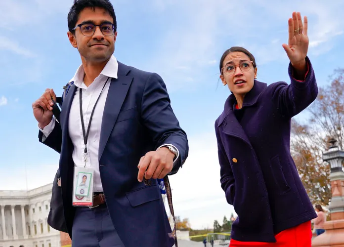 Rep.-elect Alexandria Ocasio-Cortez, D-NY, right, and her chief of staff Saikat Chakrabarti, left, walk back together after joining other members of the freshman class of Congress for a group photo on Capitol Hill in Washington.