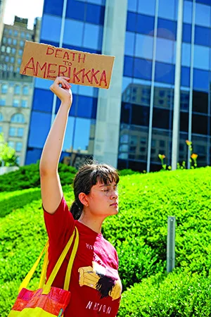A protester holds a sign that reads "Death To Amerikkka" on July 4. (Gina M Randazzo / ZUMA Press Wire / Newscom)