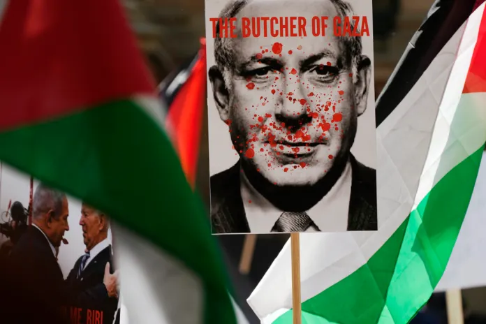 Protester carries image of Benjamin Netanyahu covered in blood at 2023 pro-Palestine rally in Sydney, Australia.