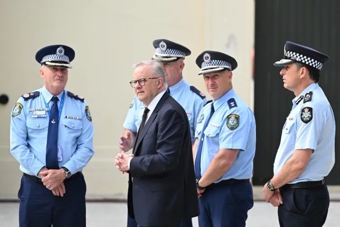 Australian Prime Minister Anthony Albanese talks to police following the Bondi Beach massacre.
