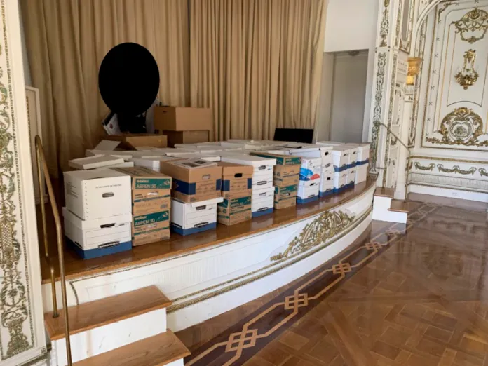 This image, contained in the indictment against former President Donald Trump, shows boxes of records being stored on the stage in the White and Gold Ballroom at Trump's Mar-a-Lago estate in Palm Beach, Fla. Trump is facing 37 felony charges related to the mishandling of classified documents, according to an indictment unsealed Friday, June 9, 2023. (Justice Department via AP)