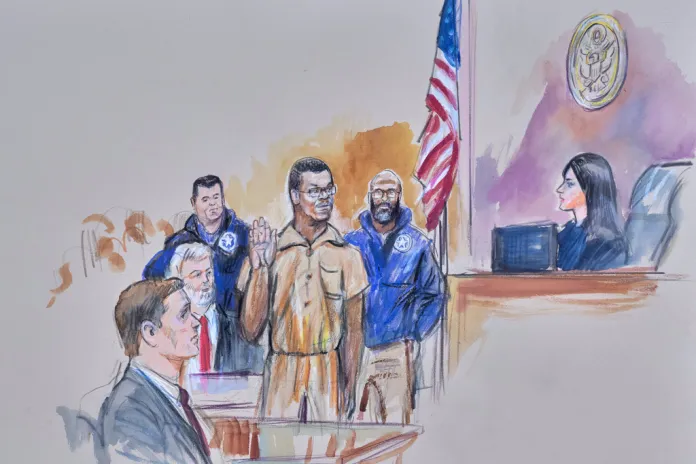 A courtroom sketch of Brian Cole Jr., 30, of Woodbridge, Virginia, the man accused of planting a pair of pipe bombs outside the headquarters of the Republican and Democratic national parties on Jan. 5, 2021, in Washington, being sworn in, Friday, Dec. 5, 2025, before U.S. Magistrate Moxila Upadhyaya, at Federal Court in Washington, as U.S. Attorney Charles Jones and Defense Attorney John Shoreman look on.