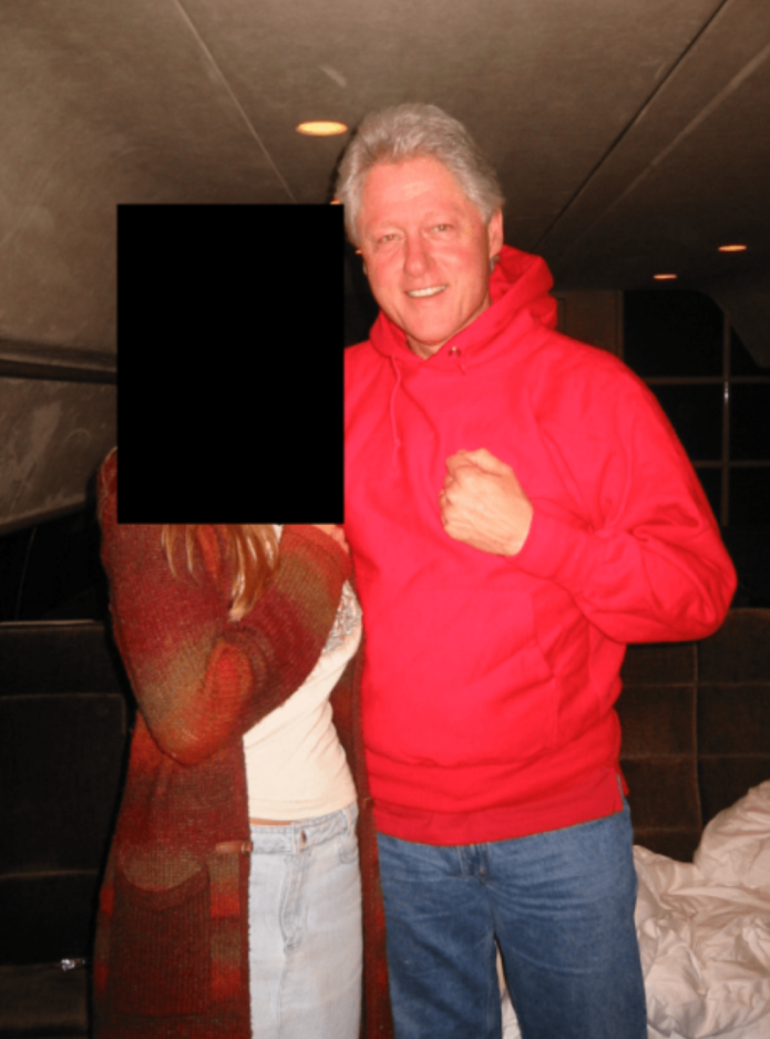 Bill Clinton stands next to another woman.