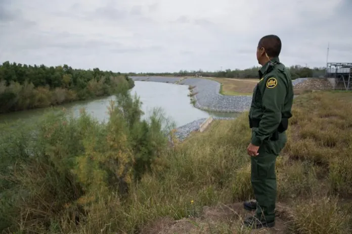 A U.S. Border Patrol agent in Texas looks out over the Rio Grande into Mexico. (Associated Press)