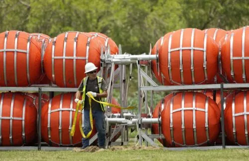 Dozens of large buoys that are set to be deployed in the Rio Grande are unloaded, Friday, July 7, 2023, in Eagle Pass, Texas, where border crossings continue to place stress on local resources. 